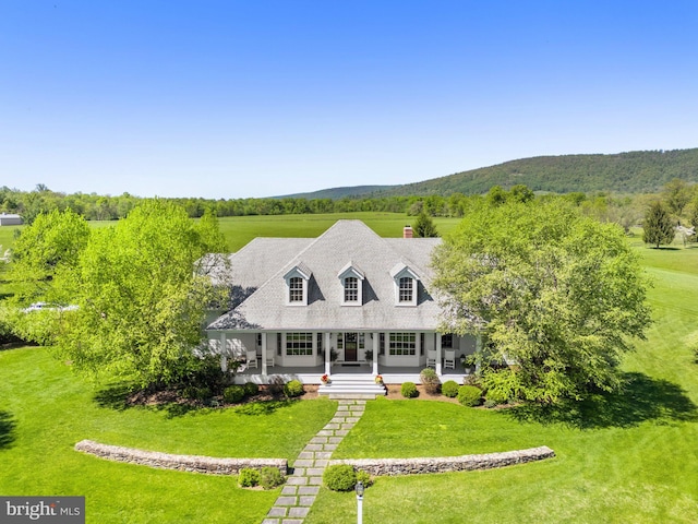 cape cod house featuring covered porch and a front yard