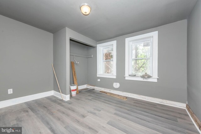 1412 W Baltimore St, Baltimore, MD 21223 - unfurnished bedroom featuring wood finished floors, baseboards, and a closet