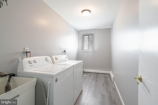 laundry room with separate washer and dryer, light wood-type flooring, and baseboards