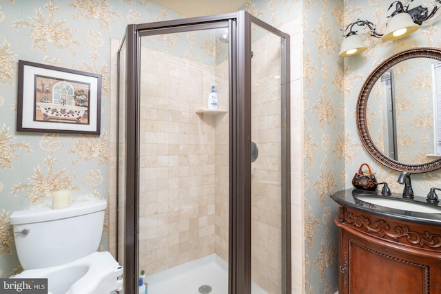 full bath with a shower stall, vanity, and toilet