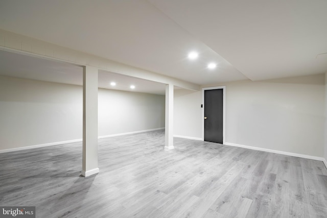 finished basement featuring wood finished floors, recessed lighting, and baseboards