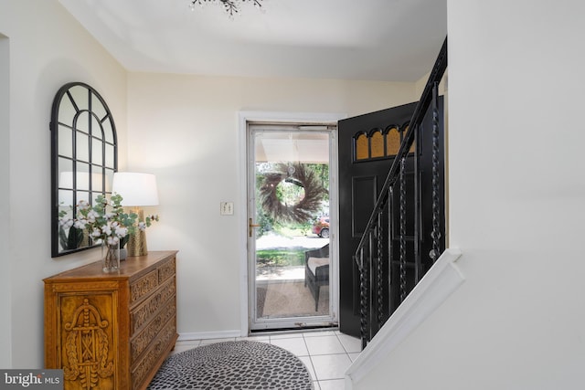 entryway with light tile patterned floors and baseboards