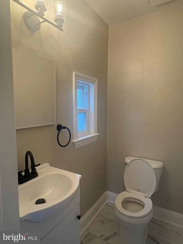 5311 Herring Run Dr, Baltimore, MD 21214 - half bathroom featuring marble finish floors, vanity, baseboards, toilet, and a chandelier