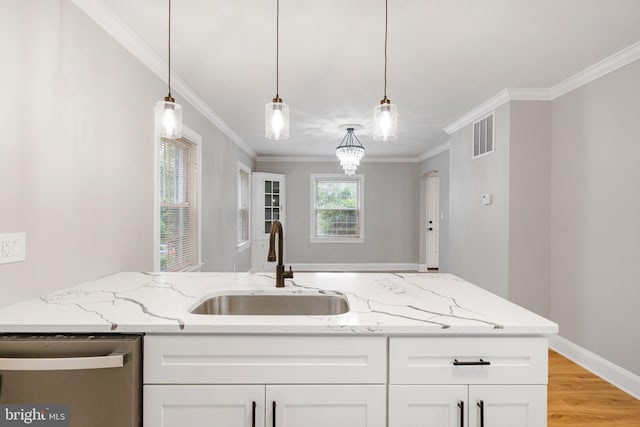 5311 Herring Run Dr, Baltimore, MD 21214 - kitchen with stainless steel dishwasher, a sink, light stone counters, crown molding, and white cabinetry