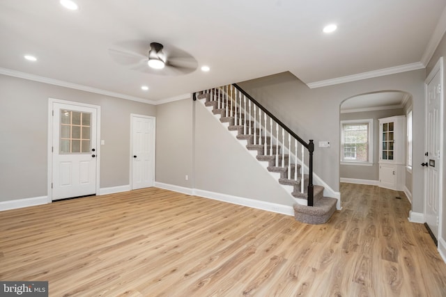 5311 Herring Run Dr, Baltimore, MD 21214 - entrance foyer featuring arched walkways, stairway, ceiling fan, light wood-type flooring, and ornamental molding