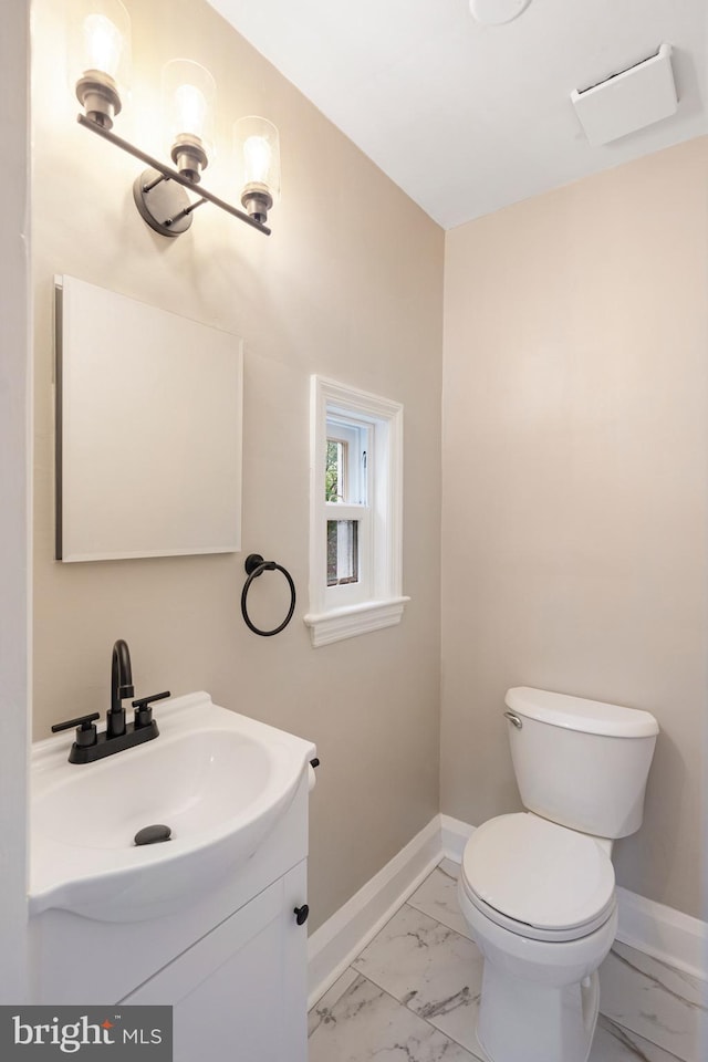 5311 Herring Run Dr, Baltimore, MD 21214 - bathroom featuring marble finish floors, baseboards, vanity, and toilet