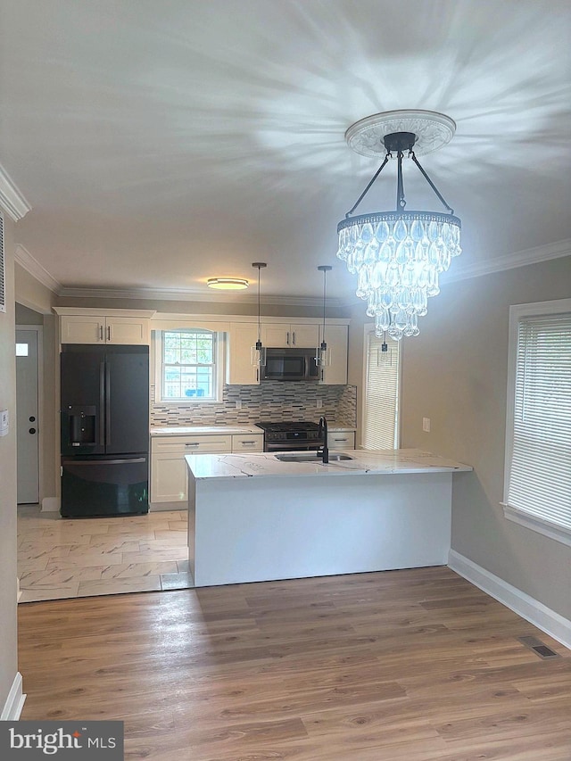 5311 Herring Run Dr, Baltimore, MD 21214 - kitchen featuring black appliances, crown molding, light countertops, light wood-style floors, and white cabinetry