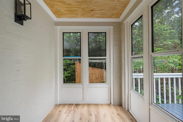 5311 Herring Run Dr, Baltimore, MD 21214 - unfurnished sunroom featuring crown molding, brick wall, and wood finished floors