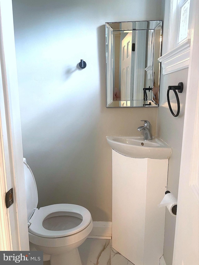 5311 Herring Run Dr, Baltimore, MD 21214 - bathroom featuring marble look tile flooring, toilet, vanity, and baseboards
