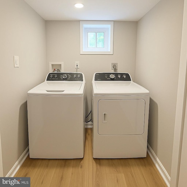 5311 Herring Run Dr, Baltimore, MD 21214 - washroom with separate washer and dryer, light wood finished floors, and baseboards
