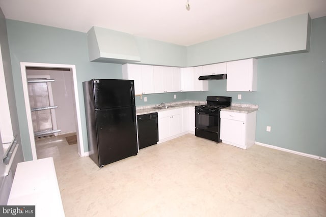 kitchen with black appliances, under cabinet range hood, a sink, white cabinets, and baseboards