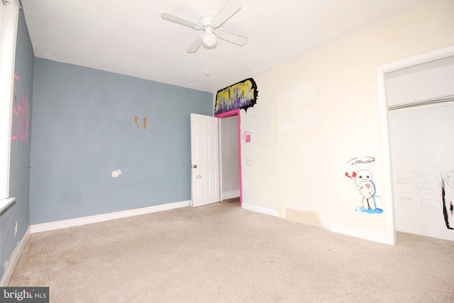 unfurnished bedroom featuring carpet flooring, baseboards, and ceiling fan