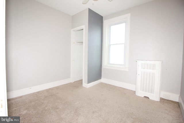 unfurnished bedroom with carpet flooring, a closet, and baseboards