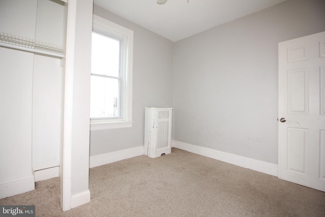 unfurnished bedroom featuring carpet, a closet, and baseboards