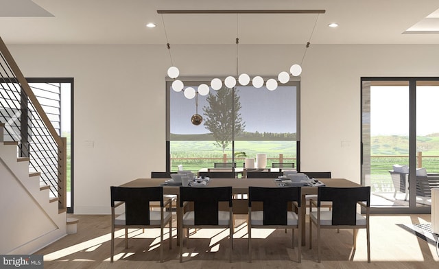 dining room featuring stairs, wood finished floors, and recessed lighting
