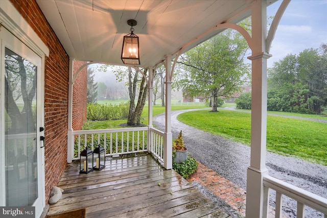 612 Old Rte 322, Spring Mills, PA 16875 - wooden deck featuring covered porch and a lawn
