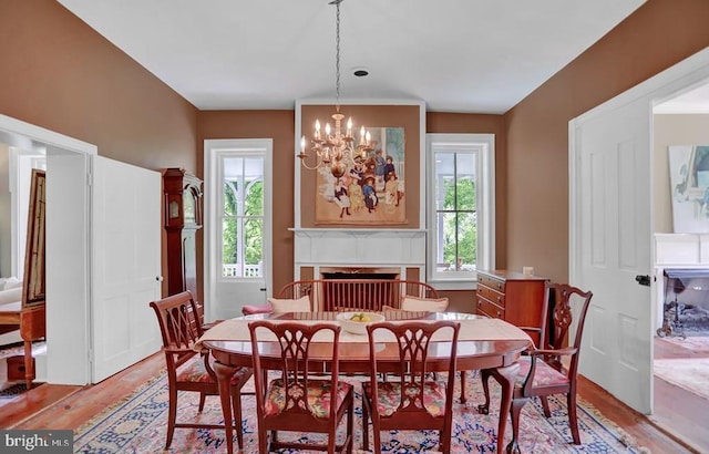 612 Old Rte 322, Spring Mills, PA 16875 - dining room with a fireplace, light wood-style flooring, and a chandelier