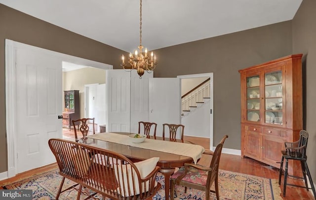 612 Old Rte 322, Spring Mills, PA 16875 - dining space with stairs, a chandelier, light wood finished floors, and baseboards