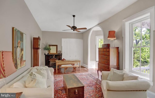 612 Old Rte 322, Spring Mills, PA 16875 - living area featuring wood finished floors, ceiling fan, arched walkways, baseboards, and vaulted ceiling