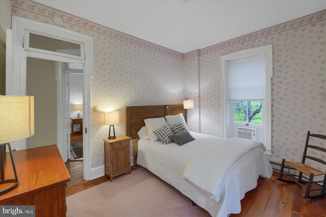 612 Old Rte 322, Spring Mills, PA 16875 - bedroom featuring hardwood / wood-style flooring, cooling unit, a baseboard heating unit, and wallpapered walls