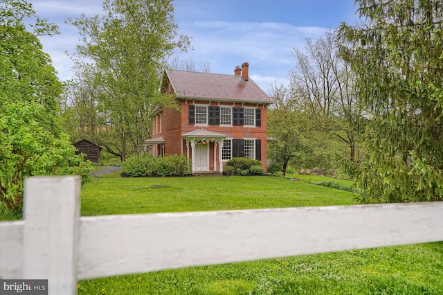 612 Old Rte 322, Spring Mills, PA 16875 - colonial home featuring a front yard, brick siding, metal roof, and a chimney