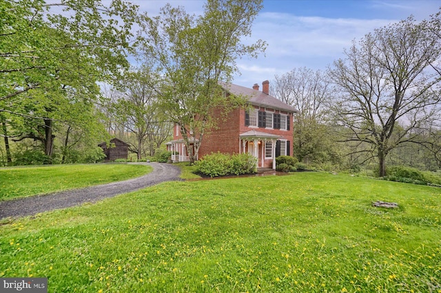 612 Old Rte 322, Spring Mills, PA 16875 - colonial home with a chimney, a front lawn, brick siding, and a shed