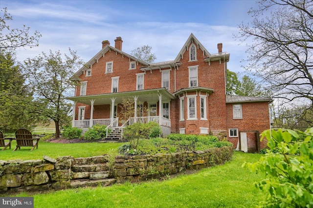 612 Old Rte 322, Spring Mills, PA 16875 - back of property featuring brick siding, covered porch, a chimney, a yard, and a standing seam roof