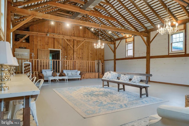612 Old Rte 322, Spring Mills, PA 16875 - living room with a chandelier, vaulted ceiling, finished concrete flooring, and wooden walls