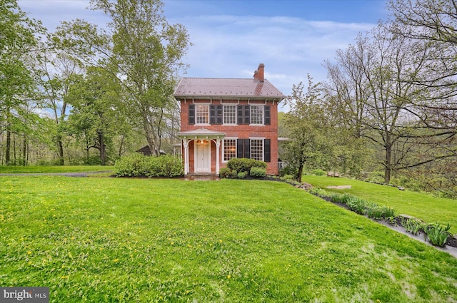 612 Old Rte 322, Spring Mills, PA 16875 - view of front of home with a chimney, a front yard, brick siding, and metal roof