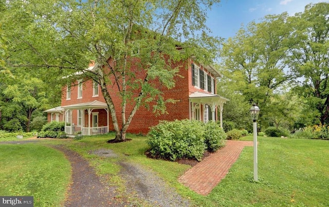 612 Old Rte 322, Spring Mills, PA 16875 - view of property exterior featuring a porch, a lawn, and brick siding