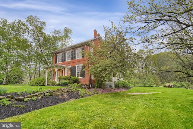 612 Old Rte 322, Spring Mills, PA 16875 - view of property exterior with a chimney, brick siding, and a lawn