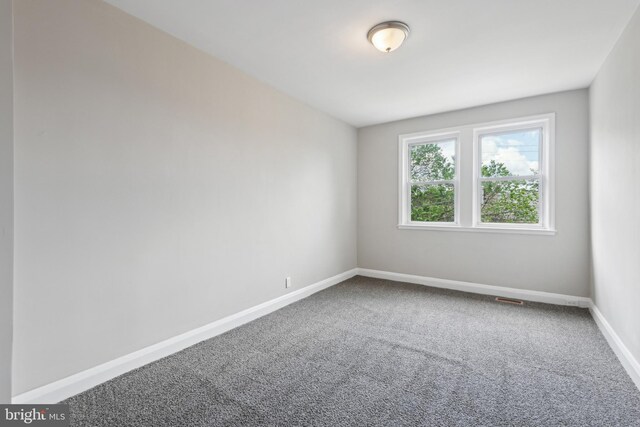 carpeted empty room with baseboards