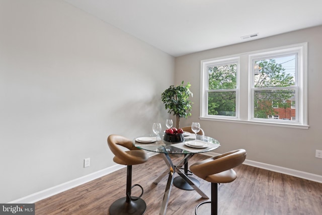 dining room featuring baseboards and wood finished floors