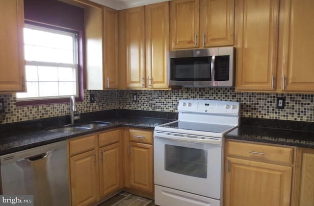 1918 Columbia Ave, Landover, MD 20785 - kitchen with appliances with stainless steel finishes, a sink, tasteful backsplash, and dark stone counters