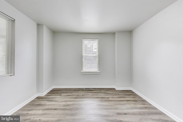 unfurnished room with wood finished floors and baseboards