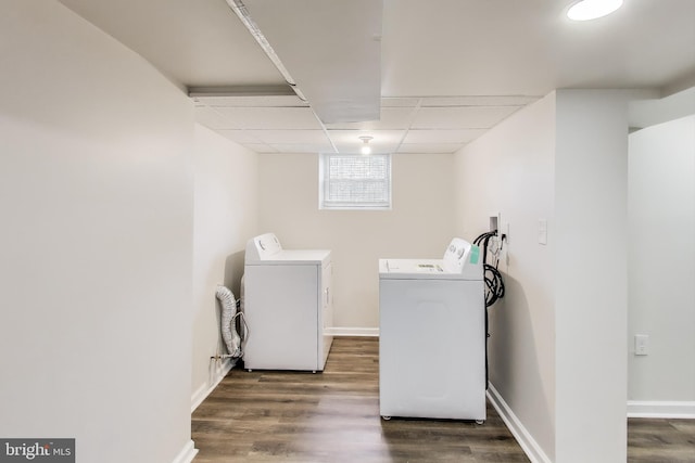washroom featuring separate washer and dryer, wood finished floors, and baseboards