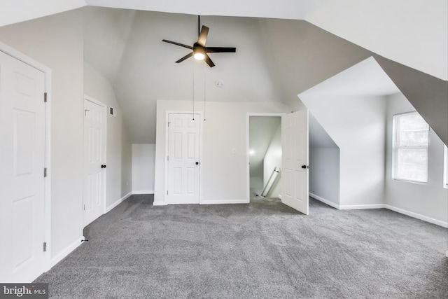 additional living space with carpet floors, vaulted ceiling, baseboards, and ceiling fan