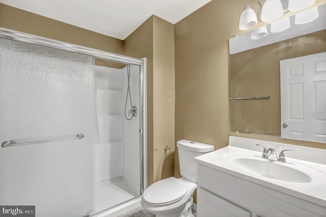 full bathroom with a shower stall, vanity, and toilet