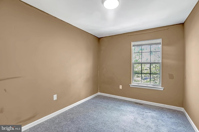 unfurnished room with carpet floors and baseboards
