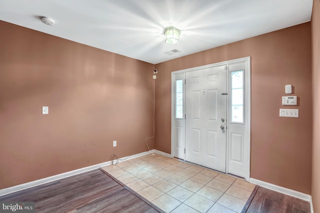 entrance foyer with baseboards and light tile patterned floors