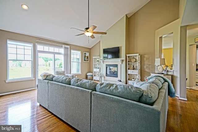 24928 Rivers Edge Rd, Millsboro, DE 19966 - living area with ceiling fan, a glass covered fireplace, wood finished floors, recessed lighting, and high vaulted ceiling