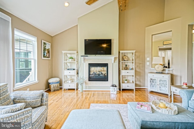 24928 Rivers Edge Rd, Millsboro, DE 19966 - living area featuring vaulted ceiling, a multi sided fireplace, and wood finished floors