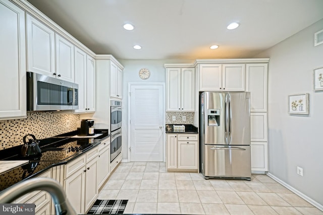 24928 Rivers Edge Rd, Millsboro, DE 19966 - kitchen with stainless steel appliances, dark countertops, decorative backsplash, light tile patterned floors, and recessed lighting