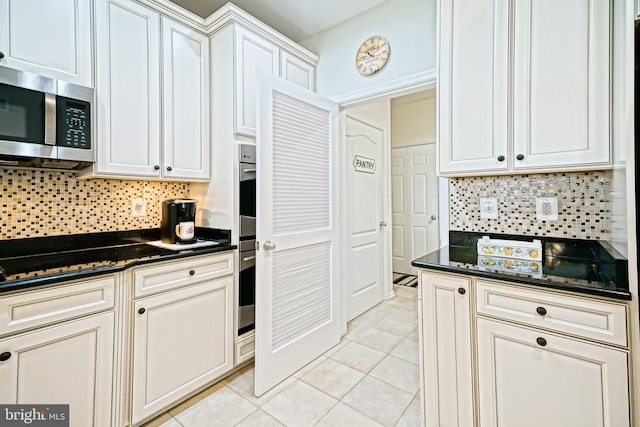 24928 Rivers Edge Rd, Millsboro, DE 19966 - kitchen with appliances with stainless steel finishes, light tile patterned floors, tasteful backsplash, and dark stone countertops