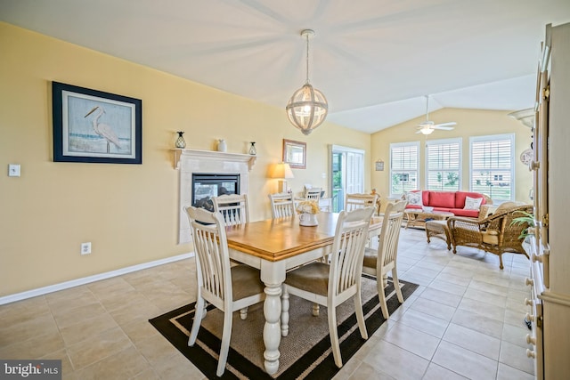 24928 Rivers Edge Rd, Millsboro, DE 19966 - dining area featuring vaulted ceiling, light tile patterned floors, and a fireplace