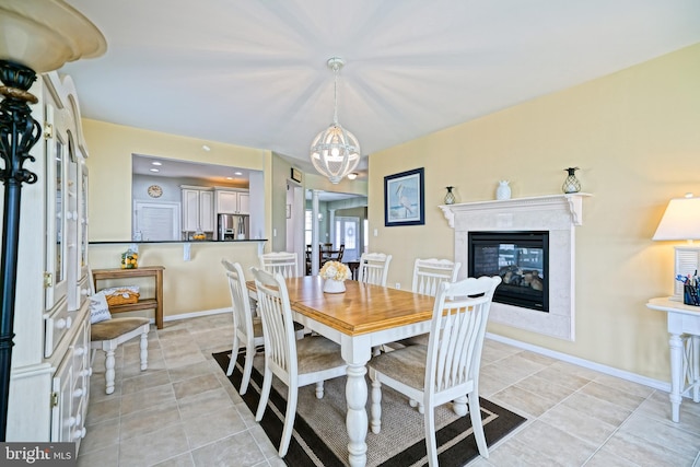 24928 Rivers Edge Rd, Millsboro, DE 19966 - dining room with a fireplace, a chandelier, and light tile patterned floors