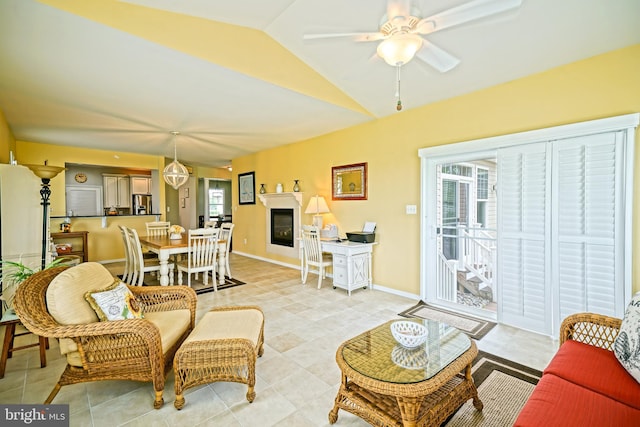 24928 Rivers Edge Rd, Millsboro, DE 19966 - living room featuring vaulted ceiling, a ceiling fan, light tile patterned floors, and a glass covered fireplace