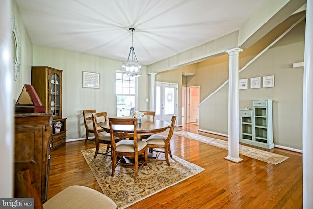 24928 Rivers Edge Rd, Millsboro, DE 19966 - dining room with ornate columns, wood finished floors, and a chandelier