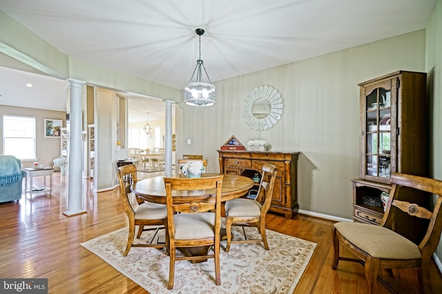 24928 Rivers Edge Rd, Millsboro, DE 19966 - dining room with decorative columns, wood finished floors, and a chandelier