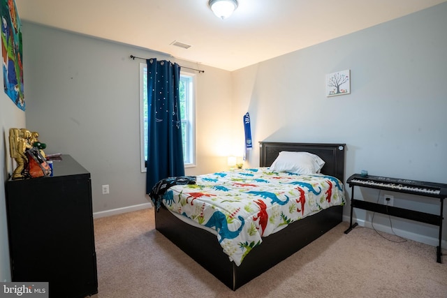 bedroom with carpet flooring and baseboards